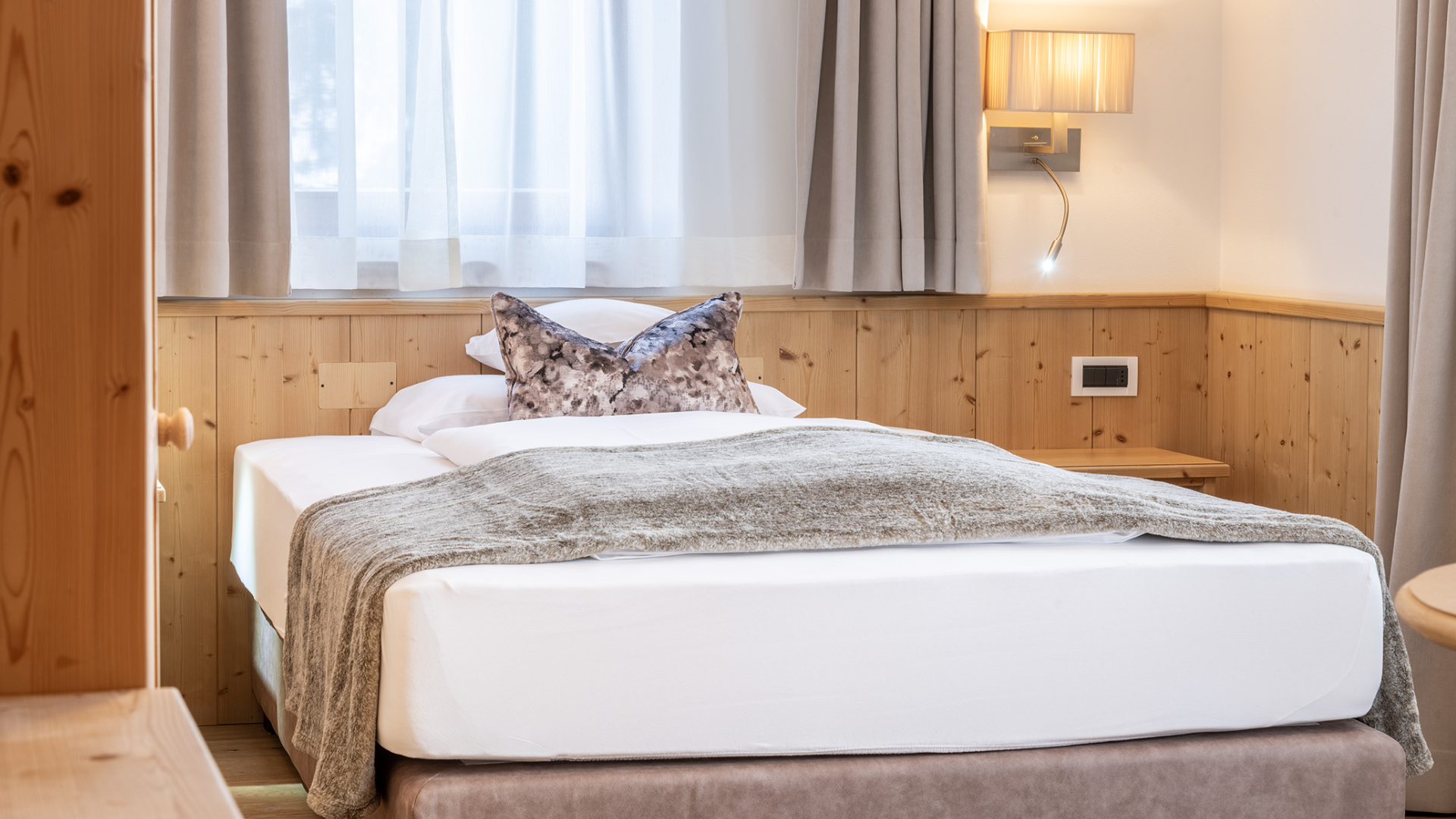 Helles Einzelzimmer mit Queensize-Bett, Details aus Naturholz